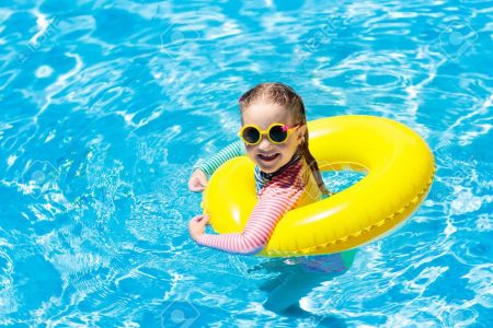 Kid on tube with yellow sunglass in the pool