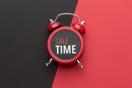 Sale time banner on black and red alarm clock
